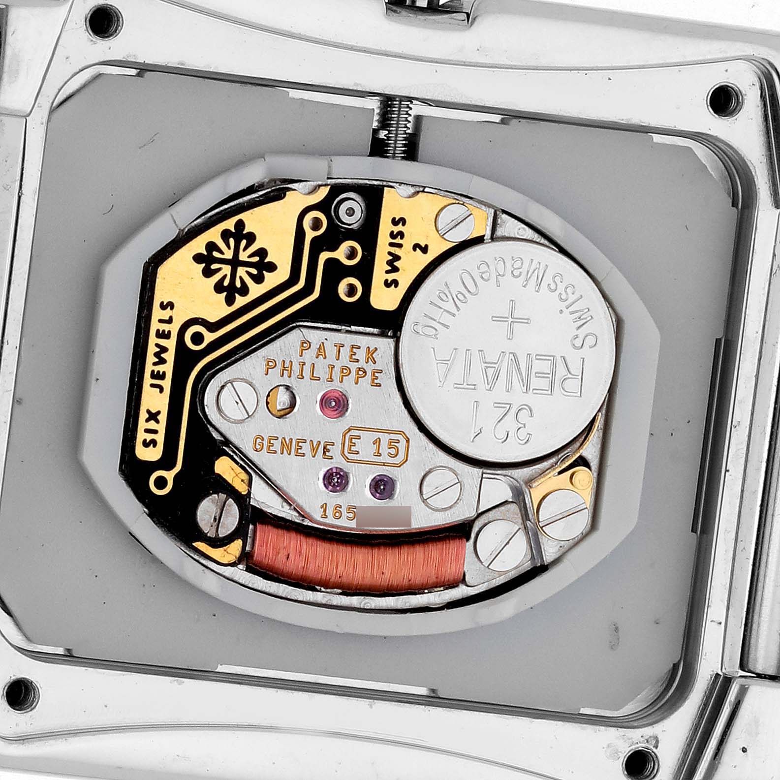 The image shows the movement of the Patek Philippe Twenty-4 4910/10 Women's White Gold Blue Dial 4910/10 Women's White Gold Blue Dial, highlighting the battery and internal components.