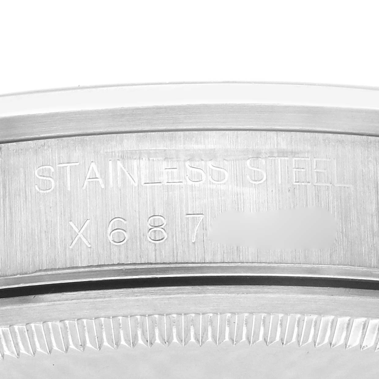The image shows a close-up of the case back edge of a Rolex Air-King 14000 Men's Stainless Steel Blue Dial 14000 Men's Stainless Steel Blue Dial with the text "STAINLESS STEEL" visible.