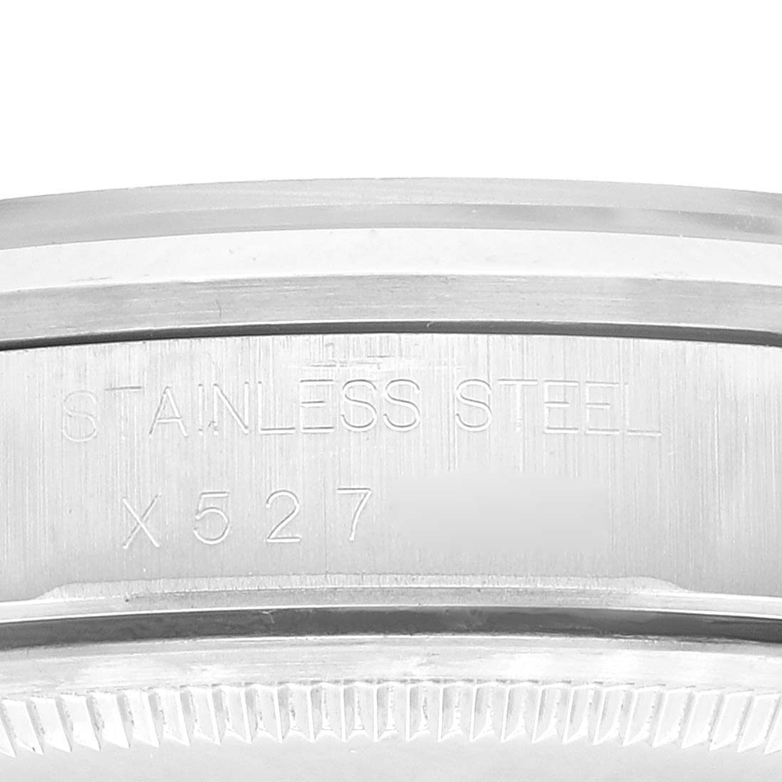 The image shows a close-up of the stainless steel engraved side of a Rolex Air-King 14000 Men's Stainless Steel Pink Dial 14000 Men's Stainless Steel Pink Dial watch case.