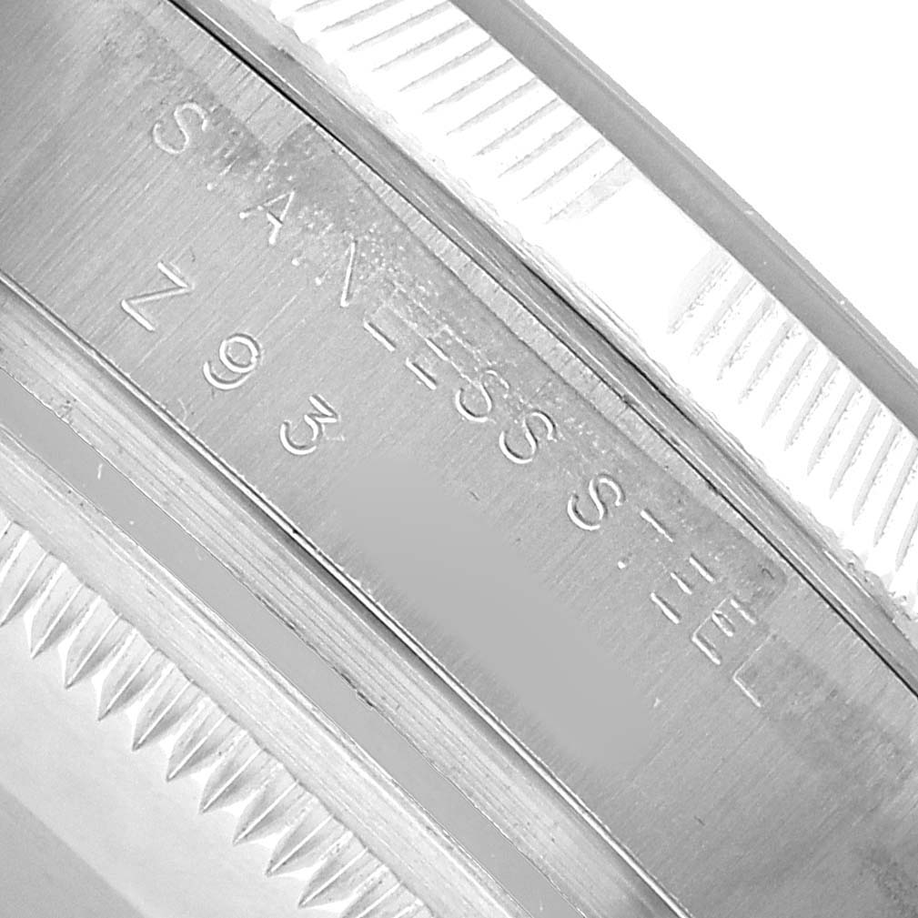 This image shows a close-up of the side engraving on the bezel of a Rolex Air-King 114210 Men's Stainless Steel Silver Dial, highlighting the stainless steel marking.