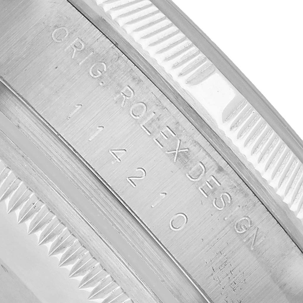 The image shows a close-up of the inner bezel with engravings on the Rolex Air-King 114210 Men's Stainless Steel Silver Dial watch.