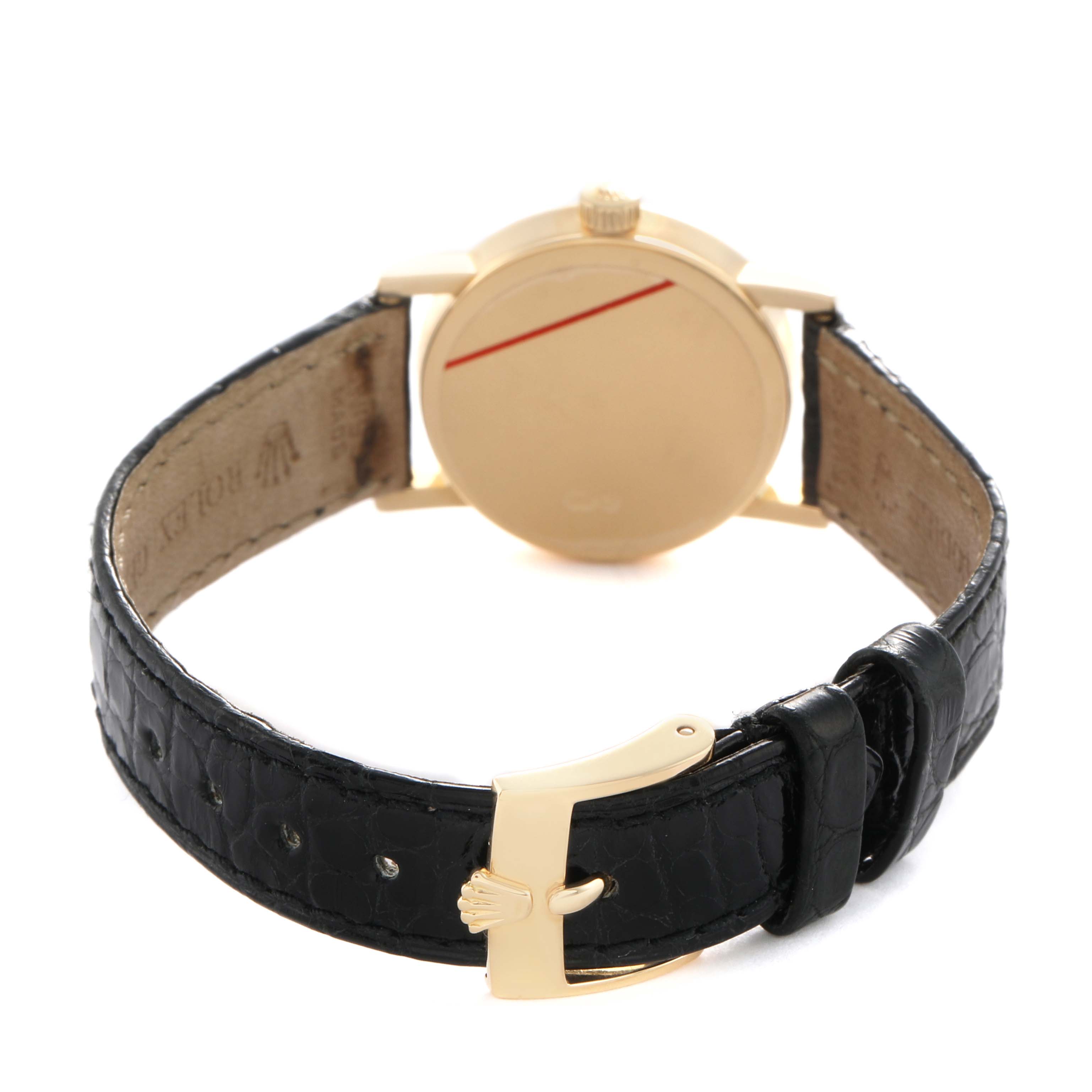 The image shows the back of a Rolex Cellini 6110 Women's Yellow Gold Mother of Pearl Dial watch with a focus on the gold clasp and black leather strap.