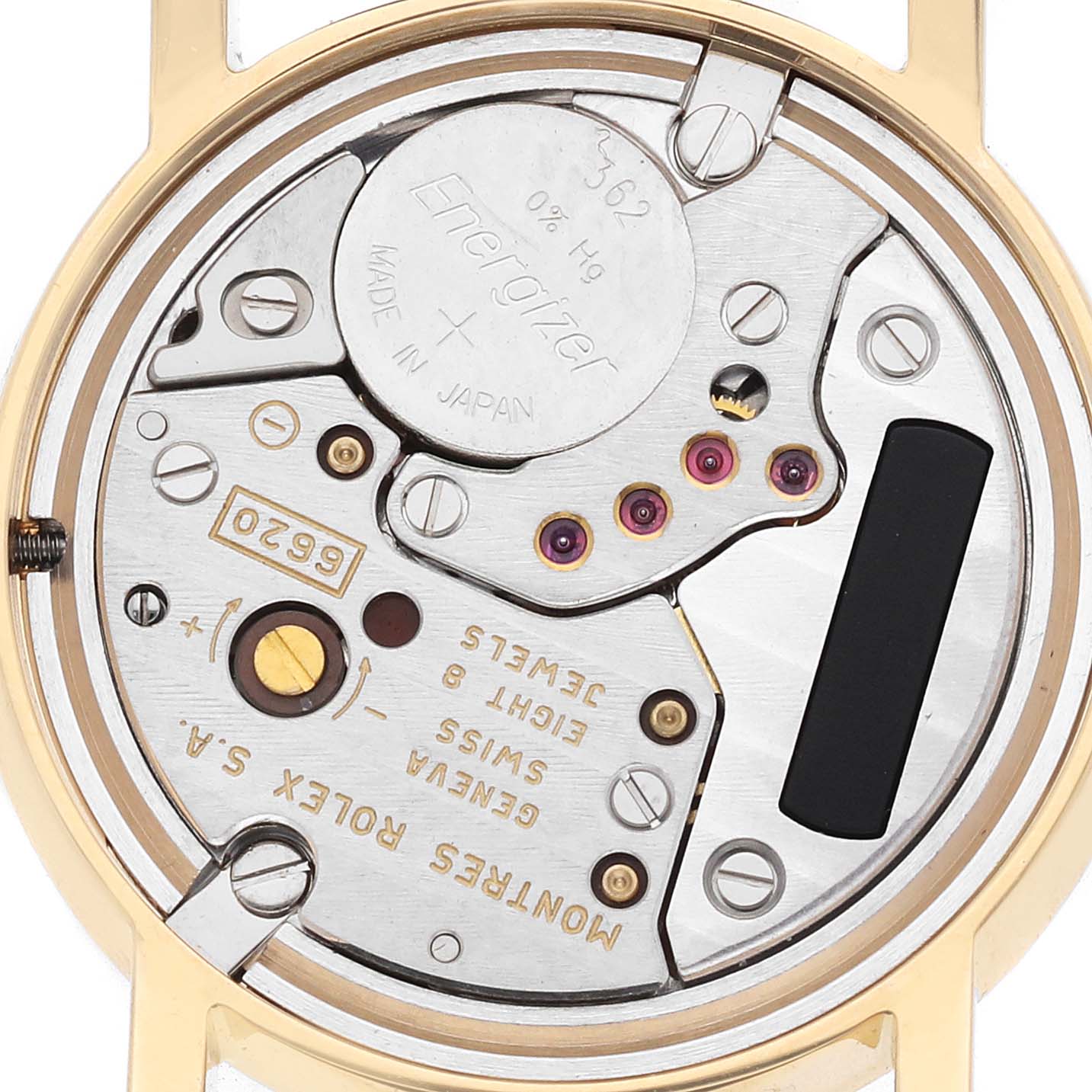 The image shows the movement of a Rolex Cellini 6110 Women's Yellow Gold Mother of Pearl Dial watch from a back angle, featuring gears, jewels, and battery components.