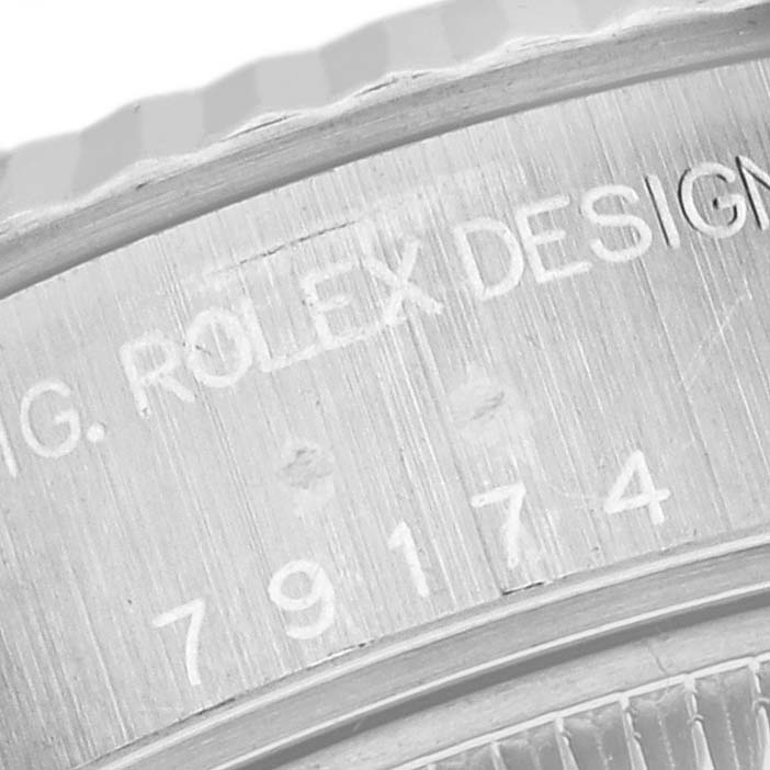 The image shows a close-up of the engraved inner bezel of a Rolex Datejust 79174 Women's Stainless Steel White Dial 79174 Women's Stainless Steel White Dial.