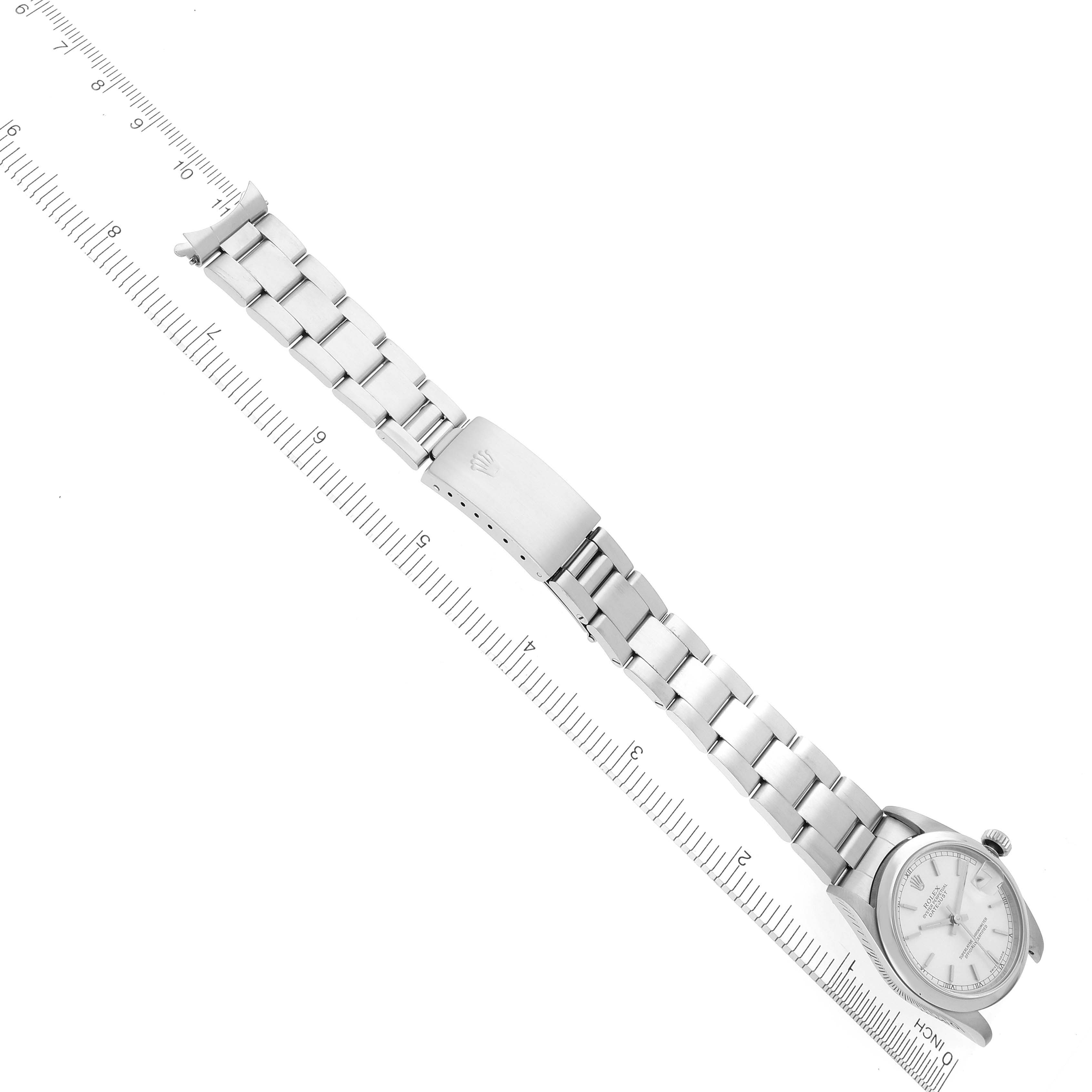 The Rolex Mid-Size 78240 Women's Stainless Steel Silver Dial 78240 Women's Stainless Steel Silver Dial watch is shown from an overhead angle, displaying the full bracelet and watch face with a ruler for scale.