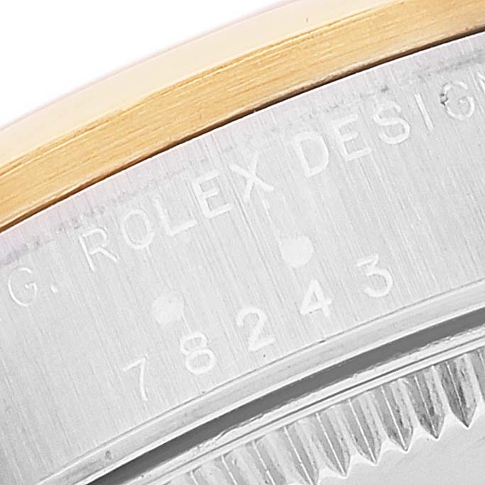 This close-up image shows the engraved serial number and bezel of the Mid-Size Rolex model.