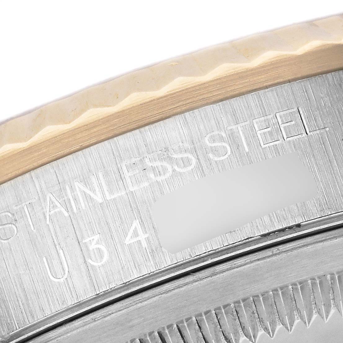 The image shows a close-up of the bezel and case edge with engraving on the Rolex Datejust 16233 Men's Steel and Gold (two tone) Black Dial 16233 Men's Steel and Gold (two tone) Black Dial.