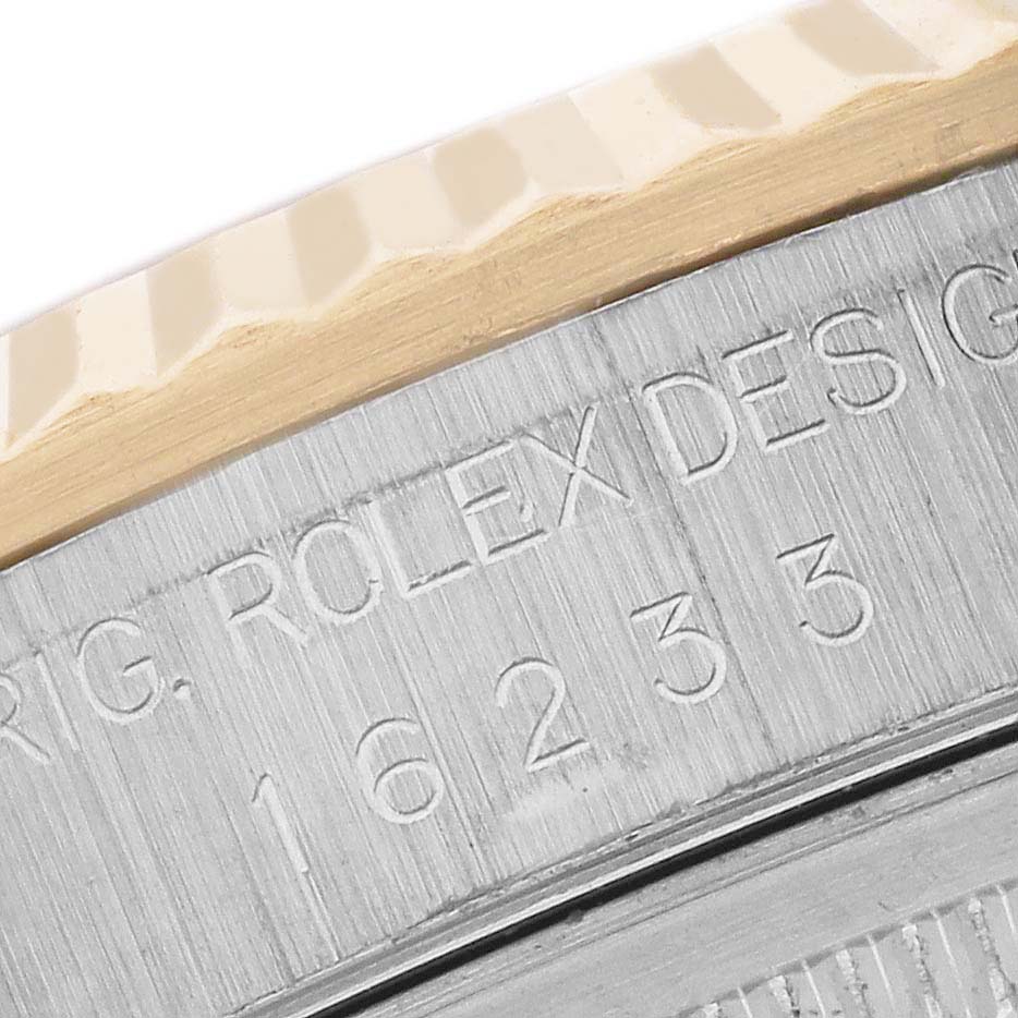 The image shows a close-up of the bezel and engraved serial number on a Rolex Datejust 16233 Men's Steel and Gold (two tone) Black Dial 16233 Men's Steel and Gold (two tone) Black Dial watch.
