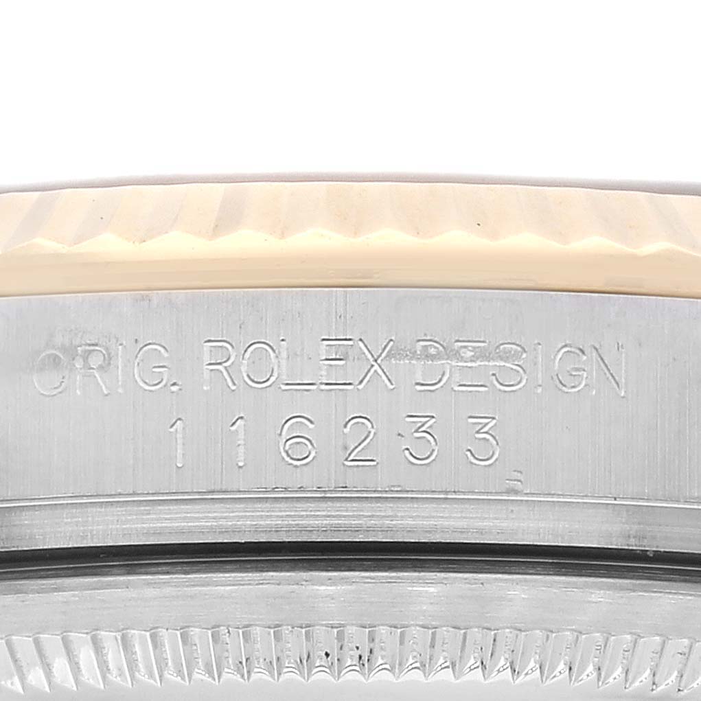This close-up image shows the Rolex Datejust 116233 Men's Steel and Gold (two tone) Champagne Dial 116233 Men's Steel and Gold (two tone) Champagne Dial model's case side with the engraved design and model number 116233.