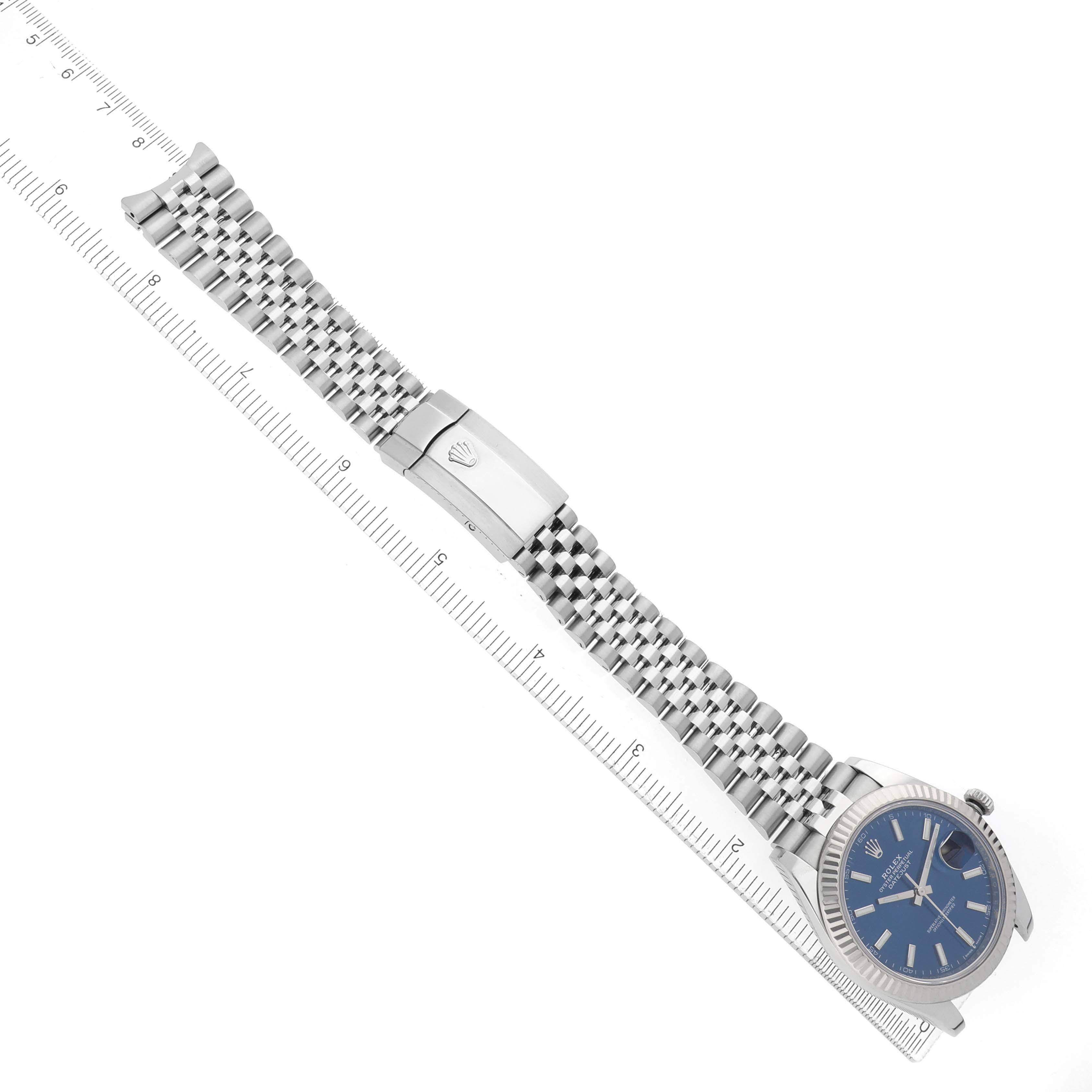 The Rolex Datejust 41 126334 Men's Stainless Steel Blue Dial is shown at a top-down angle featuring the bracelet, clasp with logo, and partially the dial.