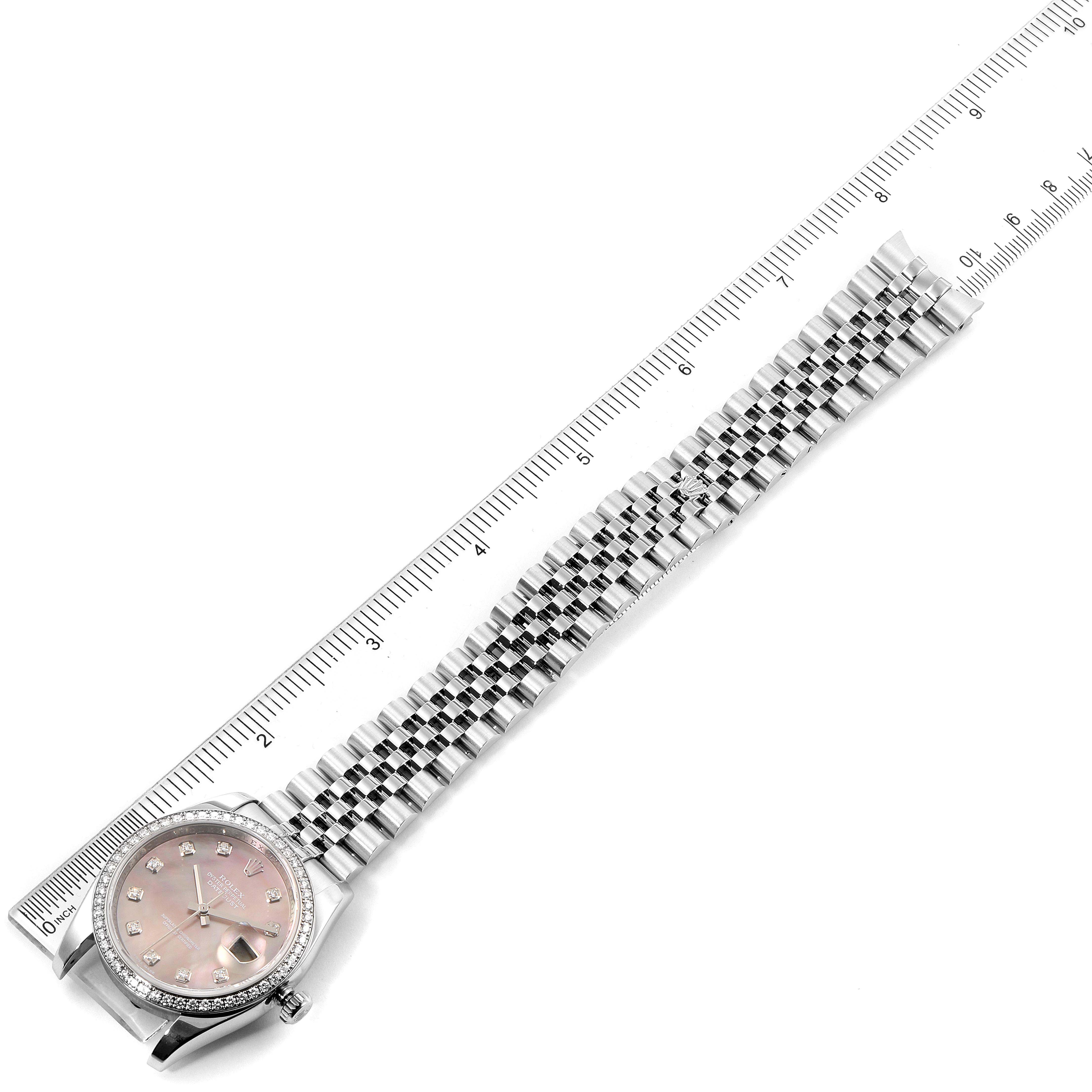 The Rolex Datejust 116244 Men's Stainless Steel Mother of Pearl Dial 116244 Men's Stainless Steel Mother of Pearl Dial watch is shown from a top-down angle, displaying the face, bezel, and entire bracelet alongside a ruler.