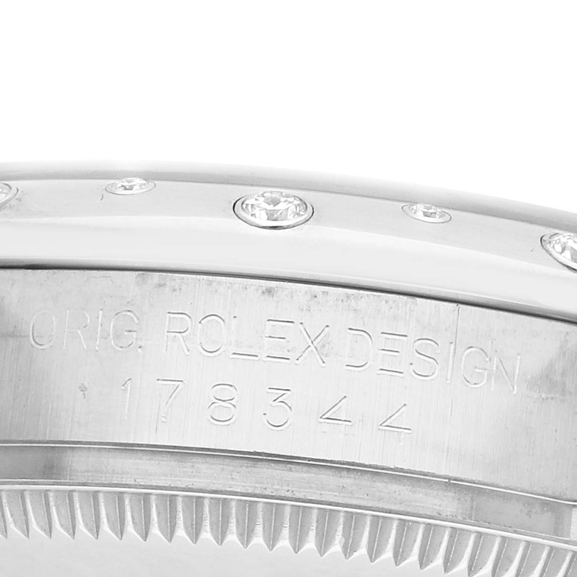 The image shows the side of a Rolex Mid-Size 178344 Women's Stainless Steel Mother of Pearl Dial watch, featuring the bezel with embedded gemstones and part of the case with engravings.