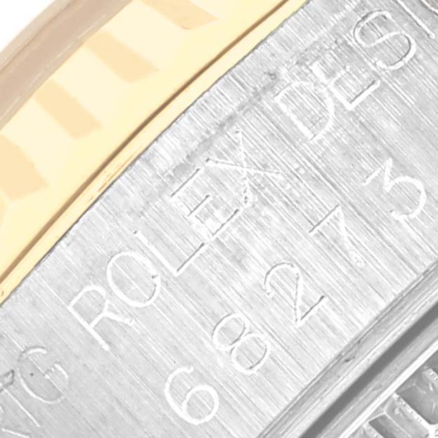 The image shows a close-up of the engraved bezel or case side of a Rolex Mid-Size 68273 Women's Steel and Gold (two tone) Silver Dial 68273 Women's Steel and Gold (two tone) Silver Dial watch.