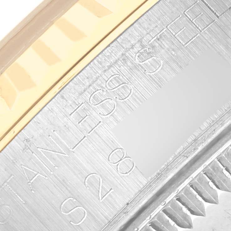 The image shows a close-up of the Rolex Mid-Size 68273 Women's Steel and Gold (two tone) Silver Dial 68273 Women's Steel and Gold (two tone) Silver Dial watch bezel with engravings and a two-tone metal finish.