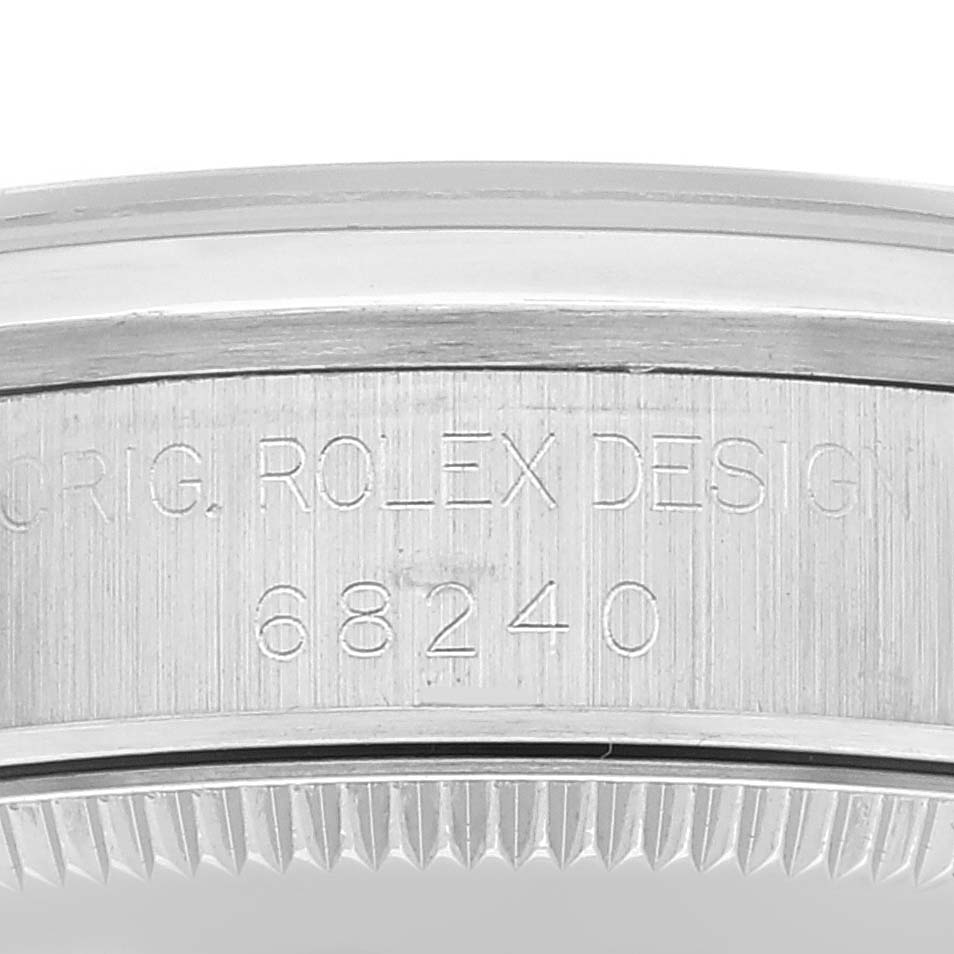 The image shows a close-up of the engraved bezel with the model number 68240 of the Rolex Mid-Size 68240 Women
s Stainless Steel Silver Dial 68240 Women
s Stainless Steel Silver Dial watch.