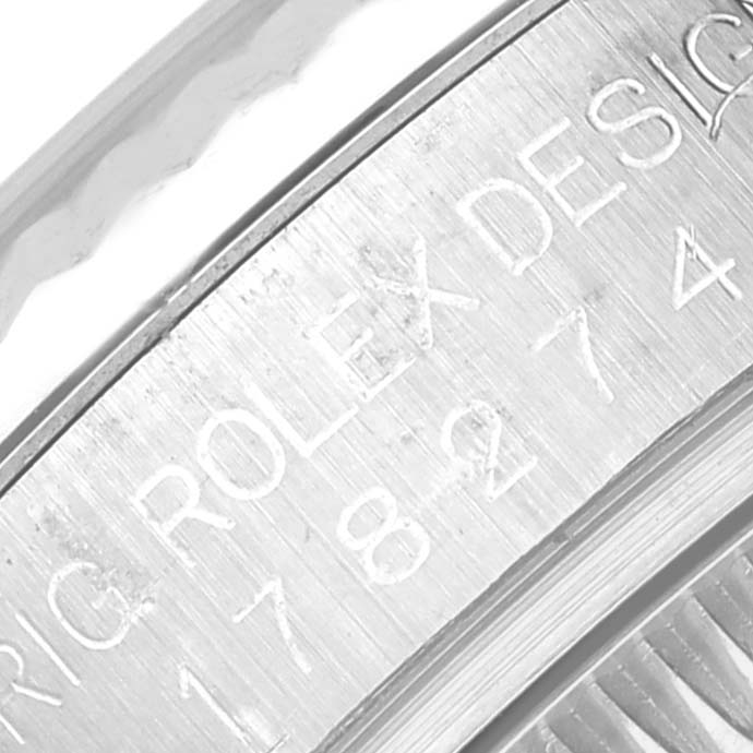 The image shows a close-up of the engraved bezel or inner ring on a Rolex Mid-Size 178274 Women's Stainless Steel Black Dial 178274 Women's Stainless Steel Black Dial watch.