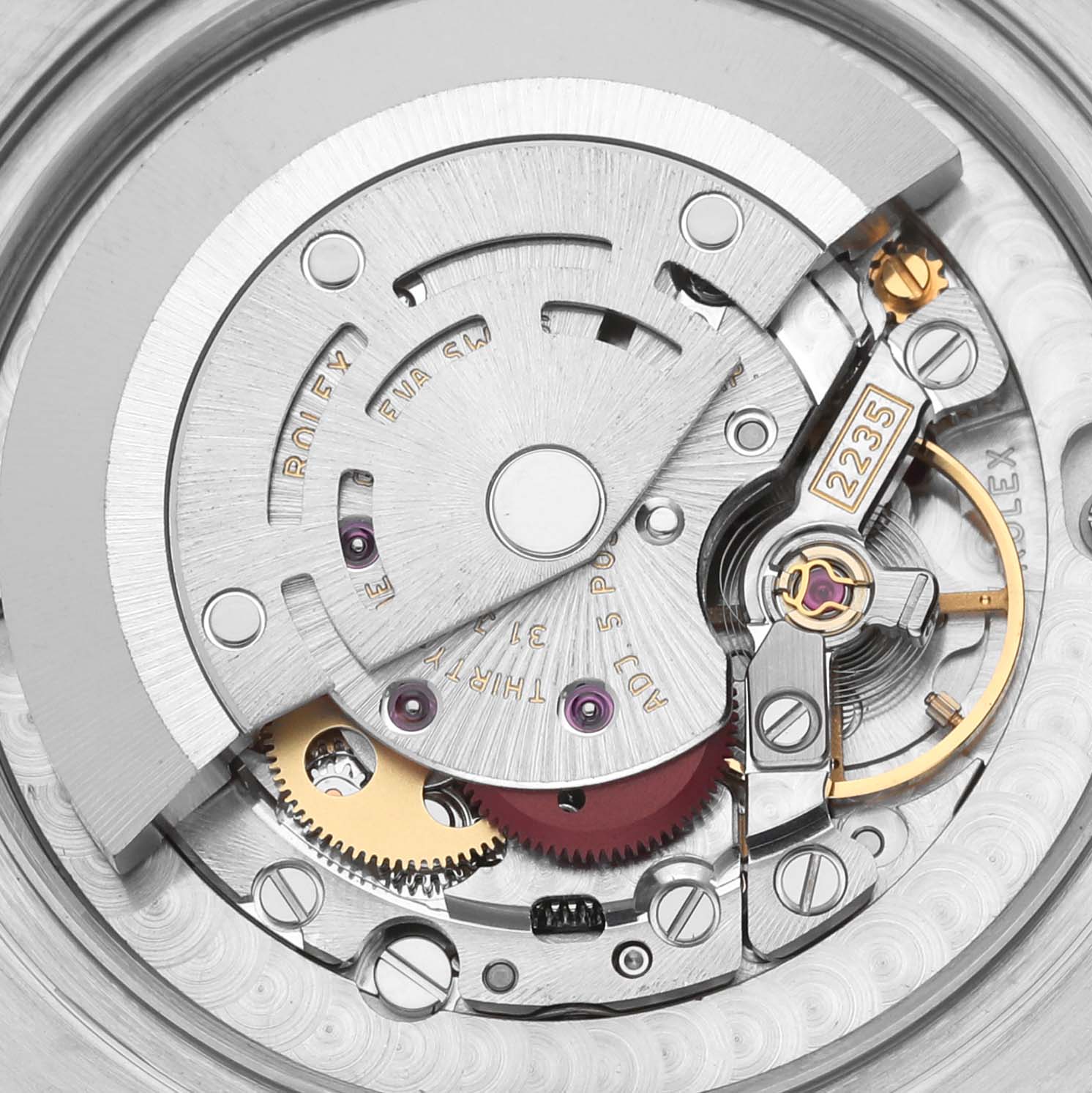 The image shows the movement mechanism of the Rolex Mid-Size 178274 Women's Stainless Steel Black Dial 178274 Women's Stainless Steel Black Dial watch, highlighting gears and the rotor at a close-up angle.
