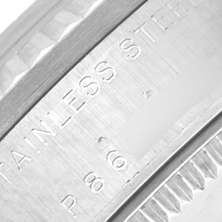 The image shows a close-up of the engraved edge of a Rolex Mid-Size 78274 Women's Stainless Steel Pink Dial 78274 Women's Stainless Steel Pink Dial watch, focusing on the "STAINLESS STEEL" marking.