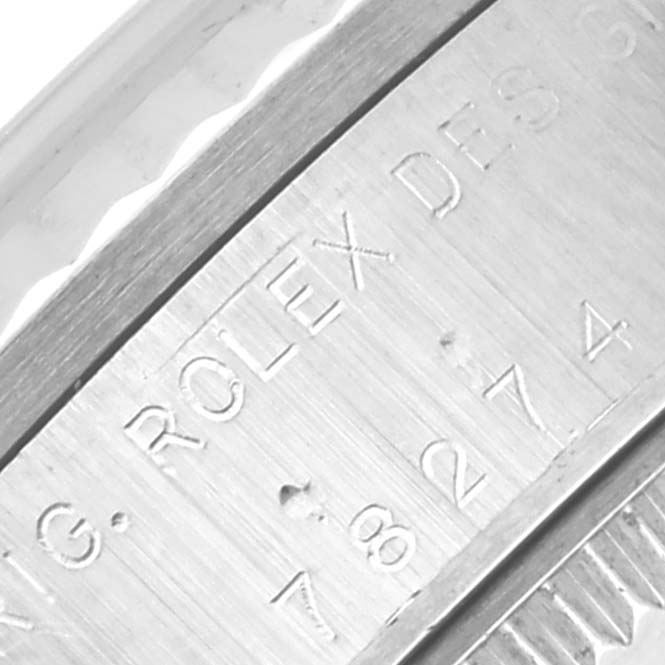 The image shows a close-up of the engraved side of a Mid-Size Rolex watch case.