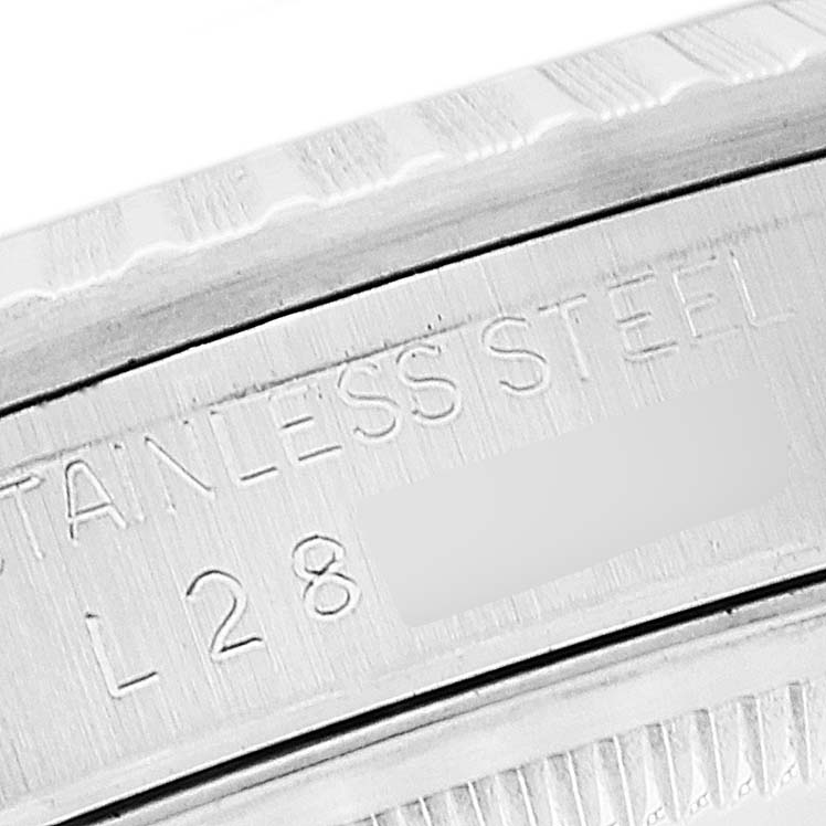 This image shows a close-up of the stainless steel bezel and engraved markings of a Rolex Datejust 16220 Men's Stainless Steel Silver Dial 16220 Men's Stainless Steel Silver Dial watch.