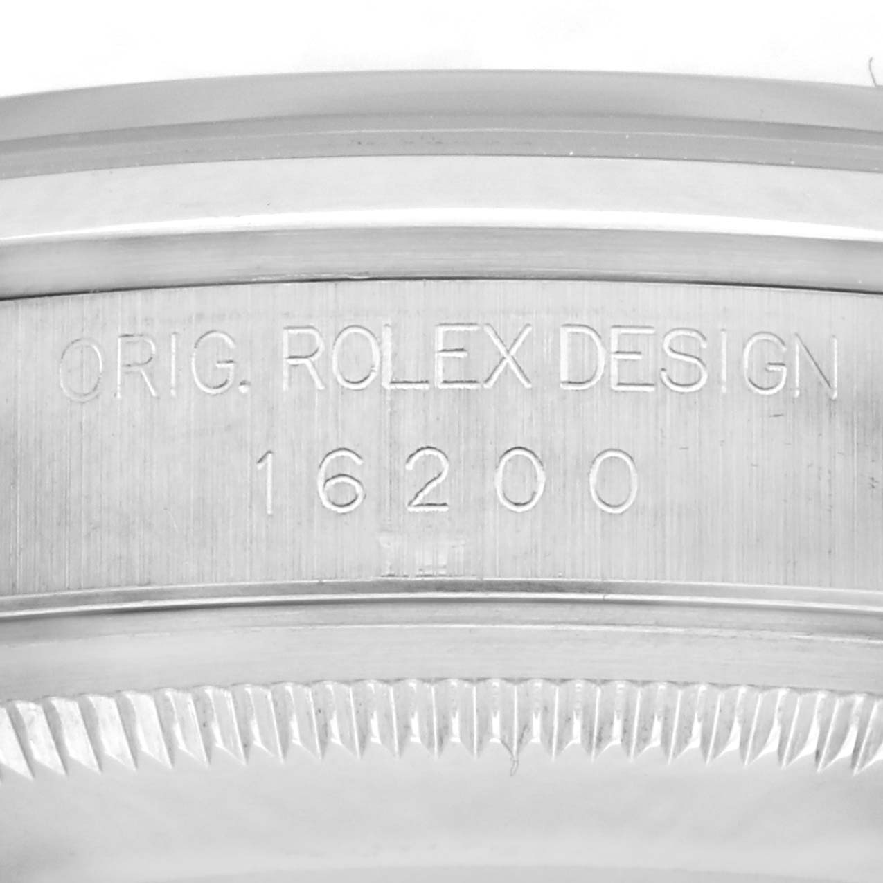 The image shows an engraved case side of the Rolex Datejust 16200 Men's Stainless Steel Silver Dial, displaying the original design number 16200.