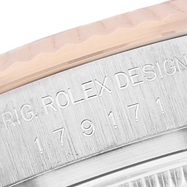 The image shows a close-up of the engraved bezel and part of the case of a Rolex Datejust 179171 Women's Steel and Gold (two tone) Pink Dial 179171 Women's Steel and Gold (two tone) Pink Dial watch.
