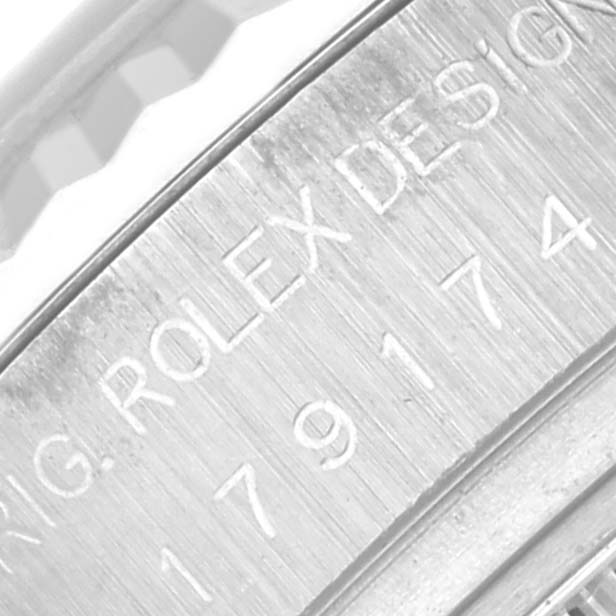 The image shows a close-up of the engraved side of a Rolex Datejust 179174 Women
s Stainless Steel Black Dial 179174 Women
s Stainless Steel Black Dial watch case.