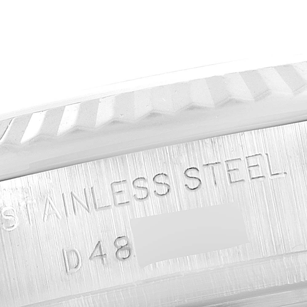 This image shows a close-up of the engraved stainless steel case of a Rolex Datejust 179174 Women
s Stainless Steel Silver Dial 179174 Women
s Stainless Steel Silver Dial watch.