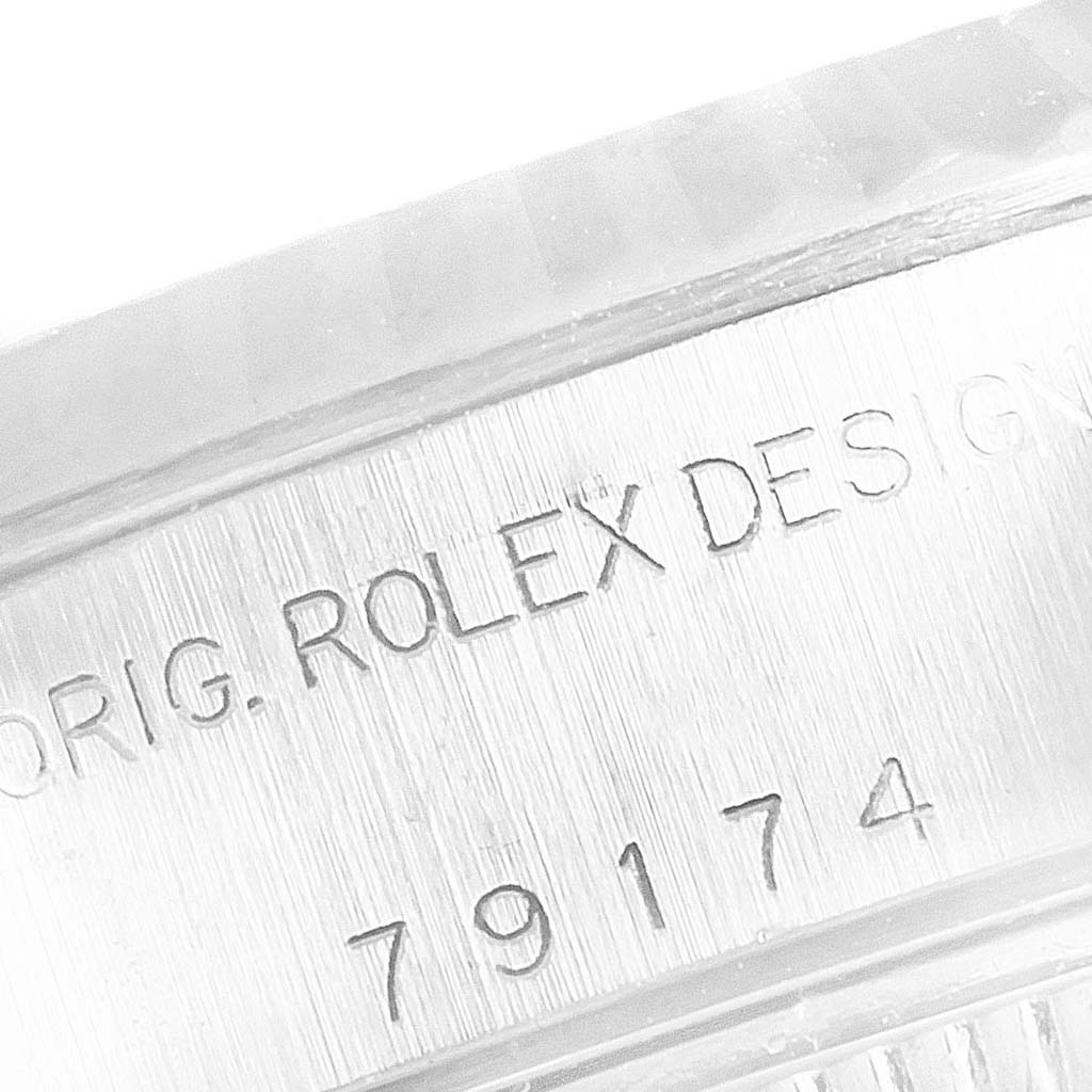 The image shows a close-up of the serial number and "ORIG. ROLEX DESIGN" engraving on the side of a Rolex Datejust 79174 Women
s Stainless Steel Pink Dial 79174 Women
s Stainless Steel Pink Dial watch case.