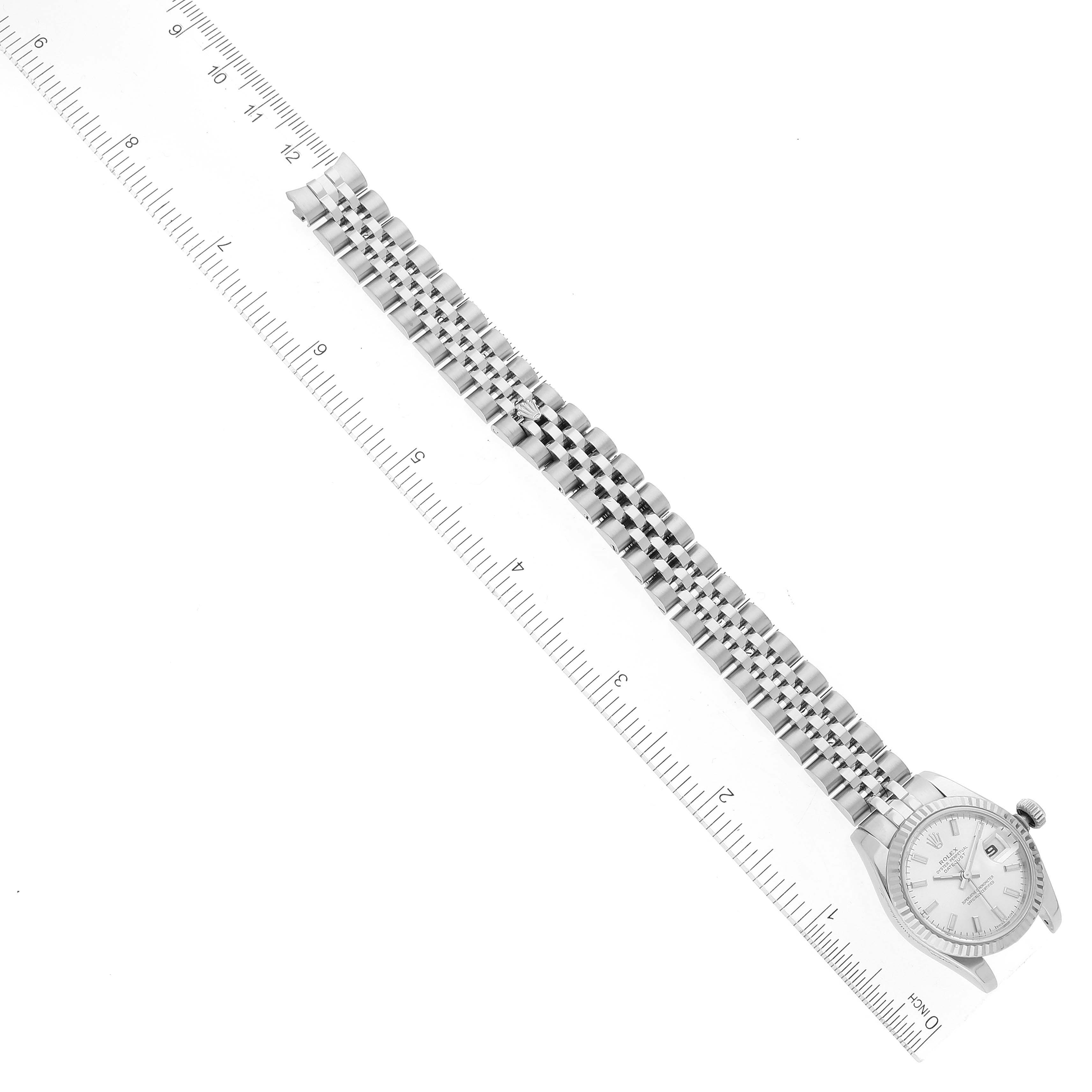 This image shows a side angle of the Rolex Datejust 179174 Women's Stainless Steel Silver Dial 179174 Women's Stainless Steel Silver Dial model, displaying the full length of the band aligned with a ruler for scale.