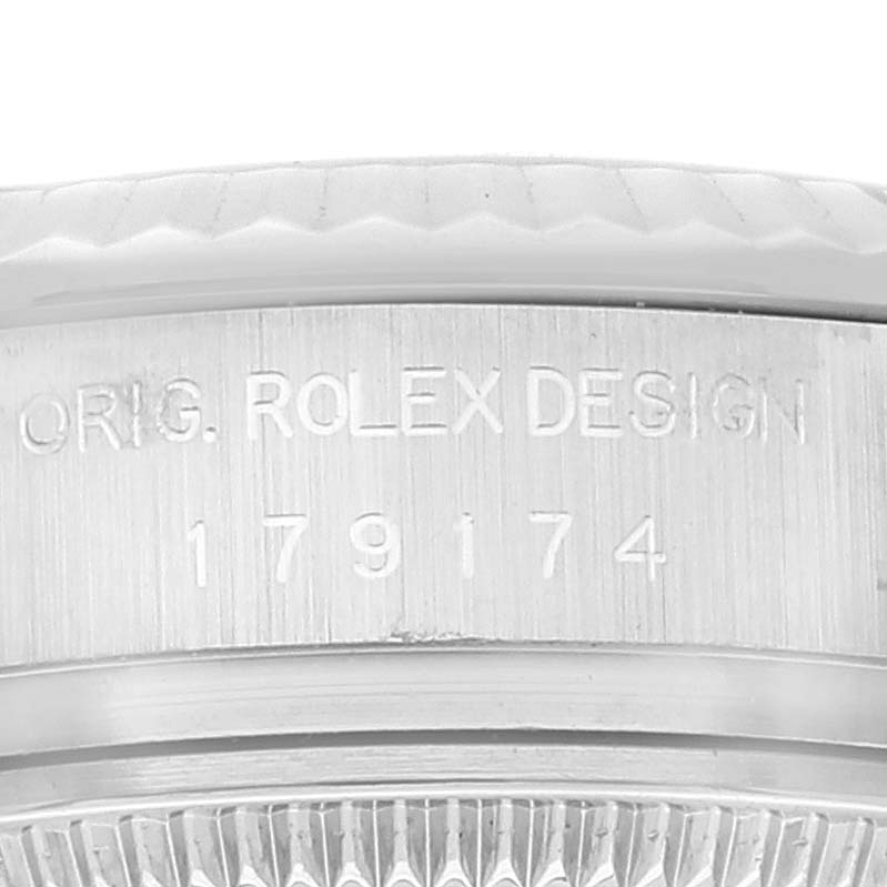 This image shows a close-up of the engraved side with the design serial number of a Rolex Datejust 179174 Women's Stainless Steel Silver Dial 179174 Women's Stainless Steel Silver Dial watch.
