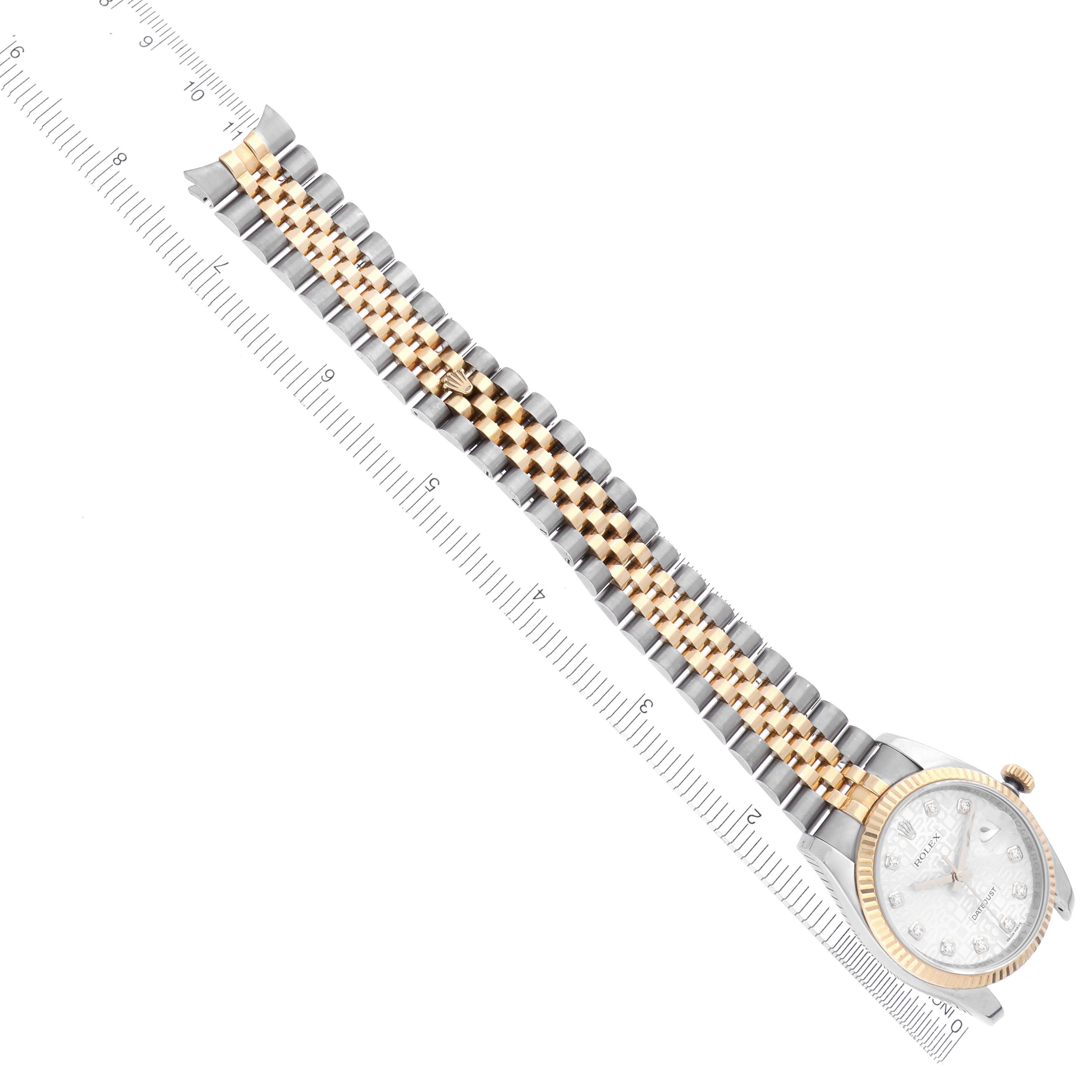 The Rolex Datejust 116233 Men's Steel and Gold (two tone) Silver Dial 116233 Men's Steel and Gold (two tone) Silver Dial watch is shown from an angled top view, highlighting the bracelet and dial with a ruler for scale.