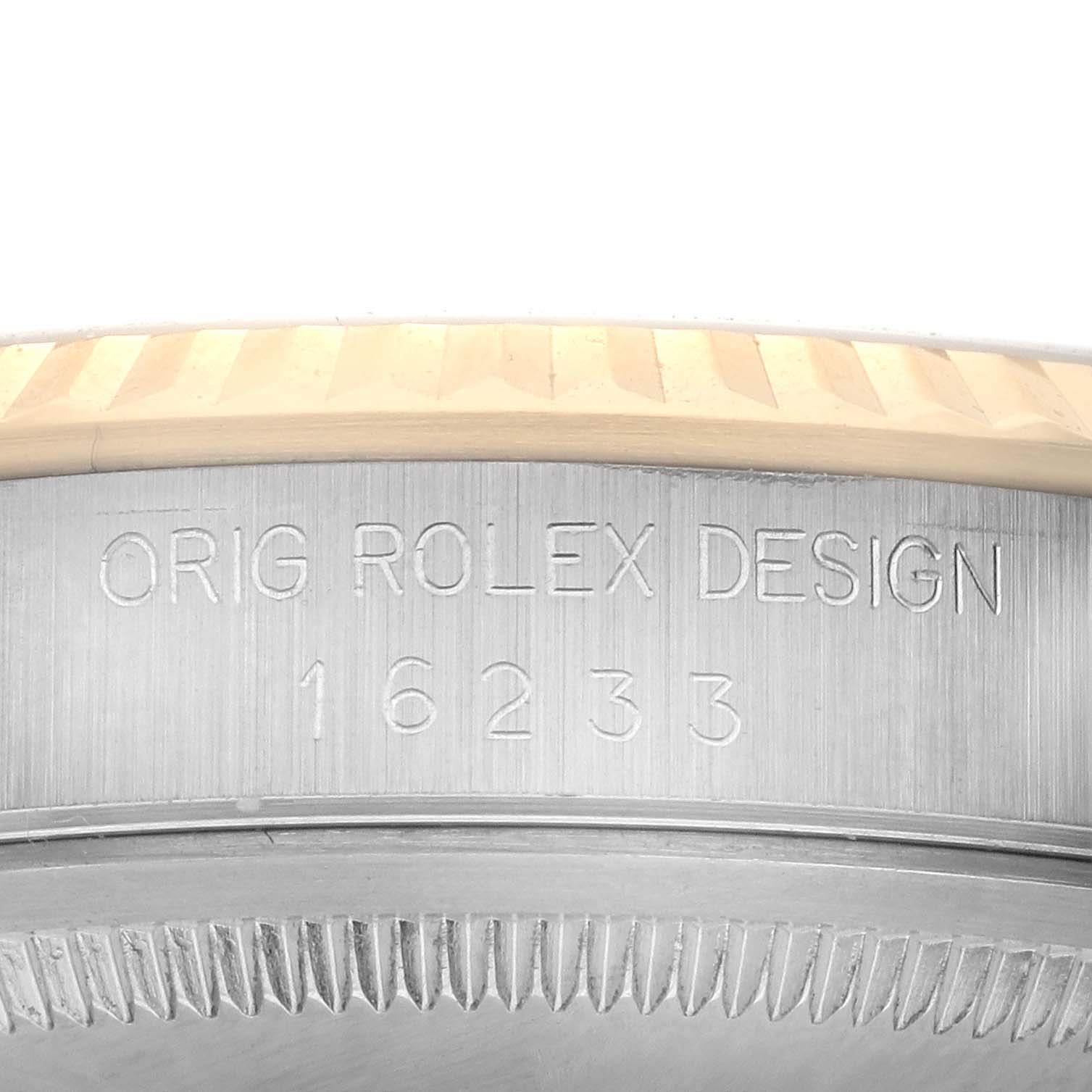 The image shows a close-up of the side of a Rolex Datejust 16233 Men
s Steel and Gold (two tone) Champagne Dial 16233 Men
s Steel and Gold (two tone) Champagne Dial watch, focusing on the "ORIG ROLEX DESIGN" and model number engraving.