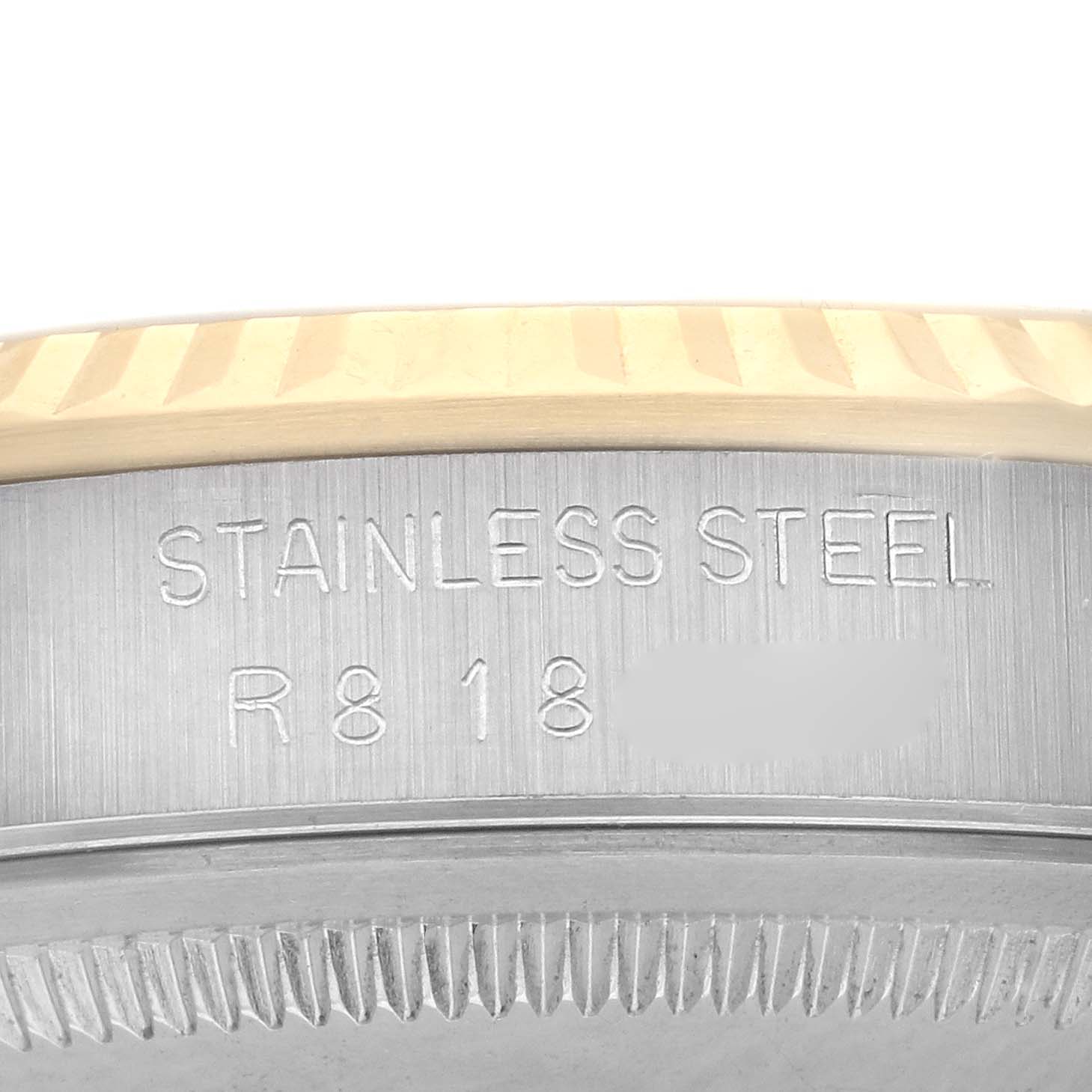 This image shows the edge and engraved serial area of a Rolex Datejust 16233 Men
s Steel and Gold (two tone) Champagne Dial 16233 Men
s Steel and Gold (two tone) Champagne Dial watch, highlighting the bezel and case side.