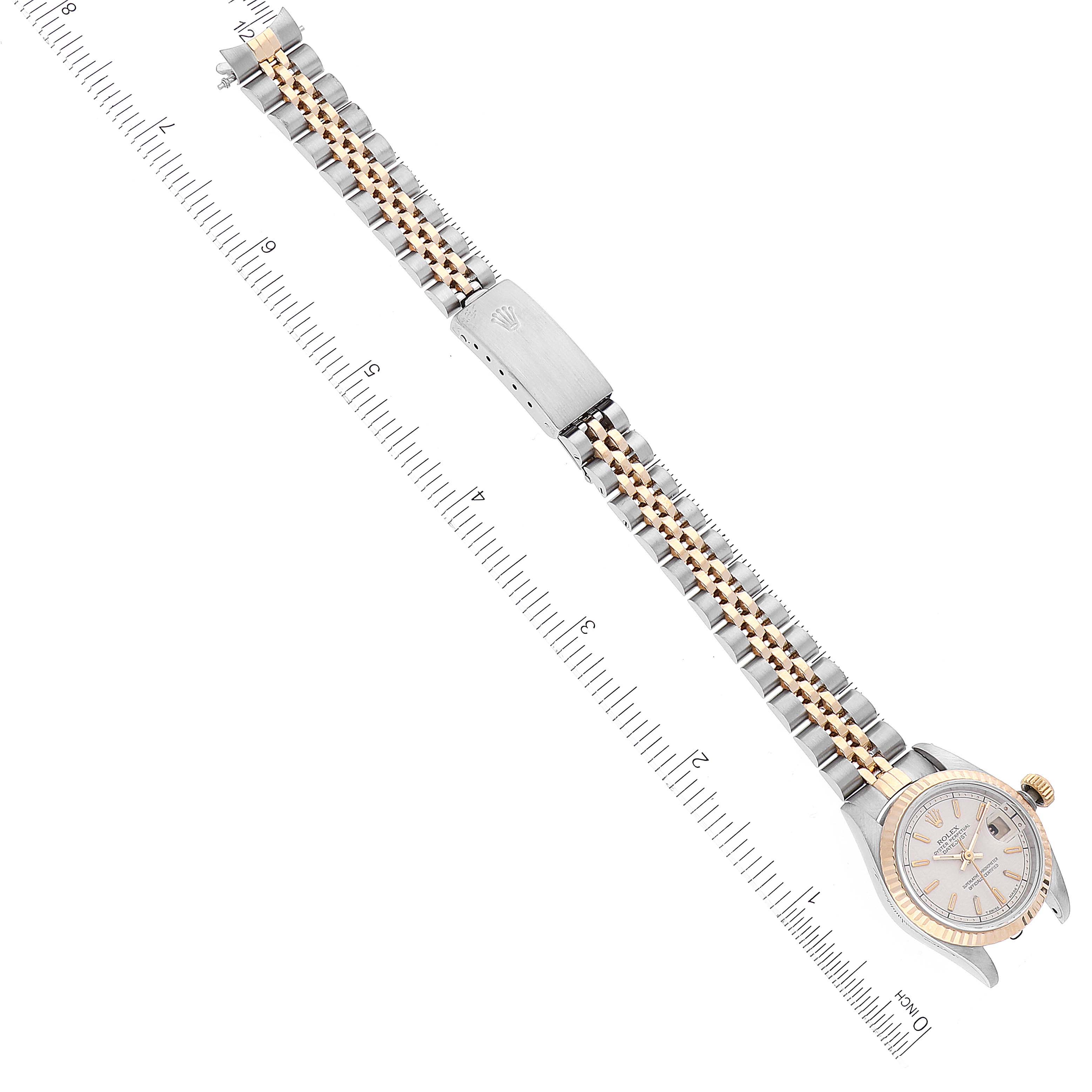 The image shows a Rolex Datejust 69173 Women's Steel and Gold (two tone) Beige Dial 69173 Women's Steel and Gold (two tone) Beige Dial watch laid flat with its face, bracelet, and clasp visible, alongside a measurement scale.