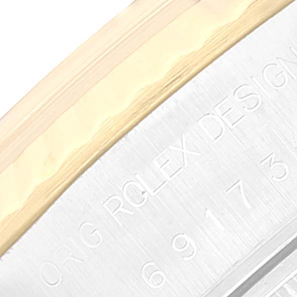 The image shows a close-up of the engraved side part of a Rolex Datejust 69173 Women's Steel and Gold (two tone) Beige Dial 69173 Women's Steel and Gold (two tone) Beige Dial watch bezel.