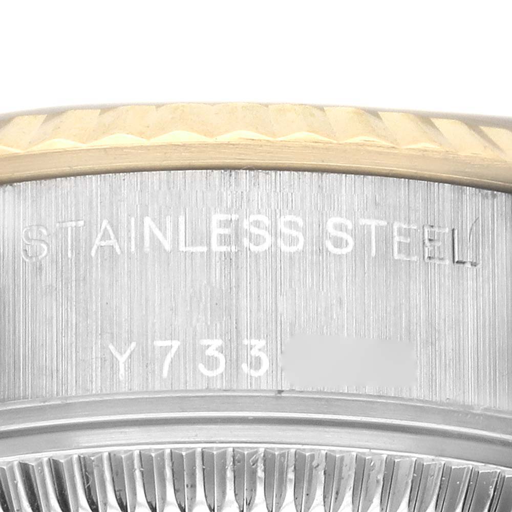 The image shows a close-up of the case back and edge of the bezel of a Rolex Datejust 79173 Women's Steel and Gold (two tone) Grey Dial 79173 Women's Steel and Gold (two tone) Grey Dial, displaying "STAINLESS STEEL" and part of a serial number.