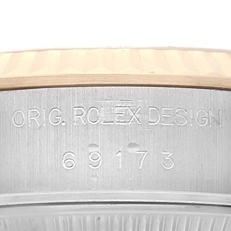 This image shows a close-up view of the engraved side of a Rolex Datejust 69173 Women's Steel and Gold (two tone) Grey Dial 69173 Women's Steel and Gold (two tone) Grey Dial watch case, featuring its model number 69173.