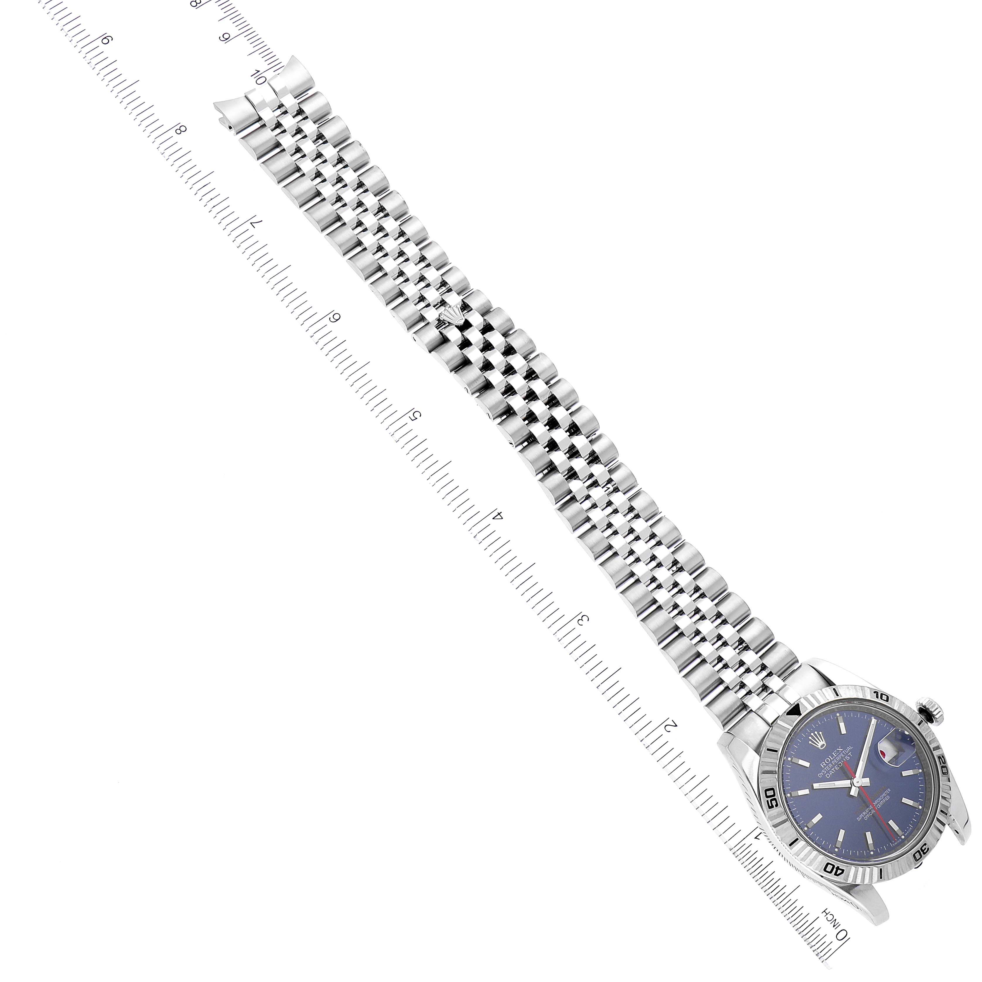 This image shows a top-down view of a Rolex Turn-o-Graph 116264 Men
s Stainless Steel Blue Dial 116264 Men
s Stainless Steel Blue Dial watch, including its face, bezel, and bracelet, aligned with a ruler.
