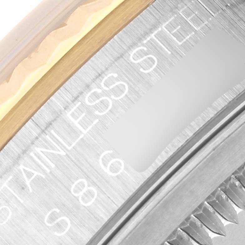 The image shows a close-up of the Rolex Datejust 16233 Men
s Steel and Gold (two tone) White Dial 16233 Men
s Steel and Gold (two tone) White Dial
s steel and gold bezel, partially displaying "STAINLESS STEEL."