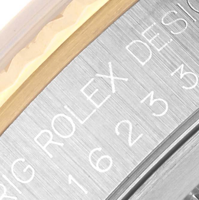 The image shows a close-up of the side engraving on the bezel of the Rolex Datejust 16233 Men
s Steel and Gold (two tone) White Dial 16233 Men
s Steel and Gold (two tone) White Dial watch.