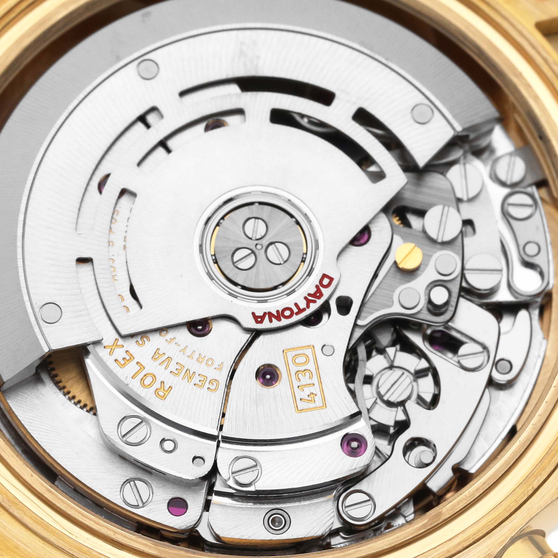 The image shows a close-up view of the Rolex Daytona 116518 Men's Yellow Gold White Dial 116518 Men's Yellow Gold White Dial watch movement from the back, revealing intricate gears and parts.
