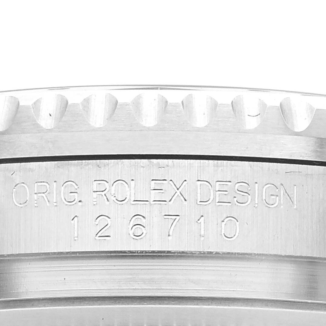 The image shows the side of a Rolex GMT-Master 126710 Men's Stainless Steel Black Dial 126710 Men's Stainless Steel Black Dial watch case with the model number 126710 engraved.