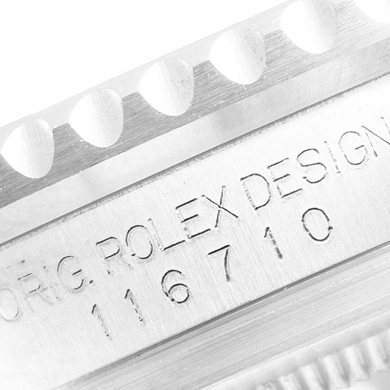 The image shows a close-up of the case side engraving and part of the bezel of a Rolex GMT-Master 116710 Men
s Stainless Steel Black Dial 116710 Men
s Stainless Steel Black Dial, model number 116710.