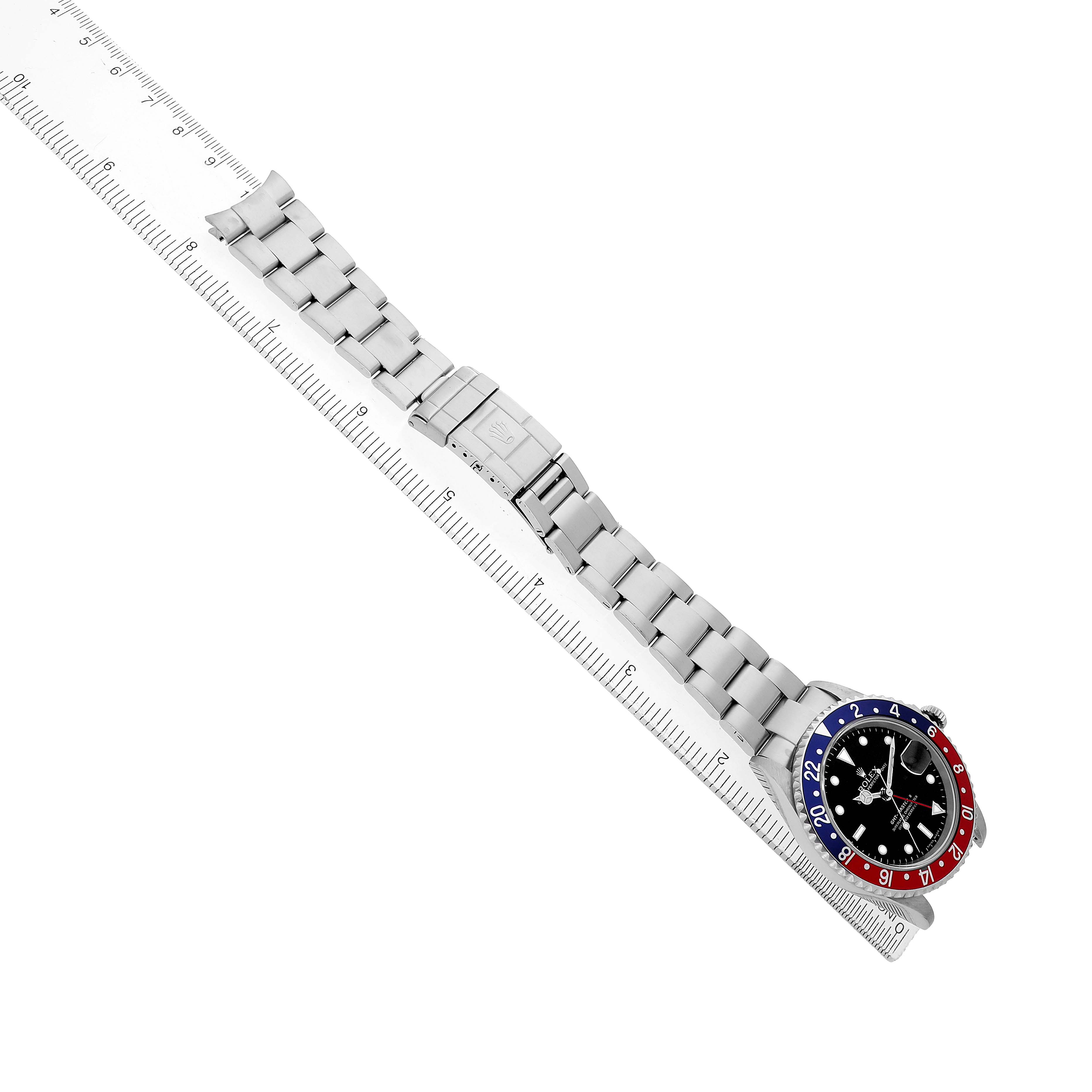 The Rolex GMT-Master 16710 Men's Stainless Steel Black Dial watch is shown flat with the bracelet extended, aligned along a ruler for measurement.