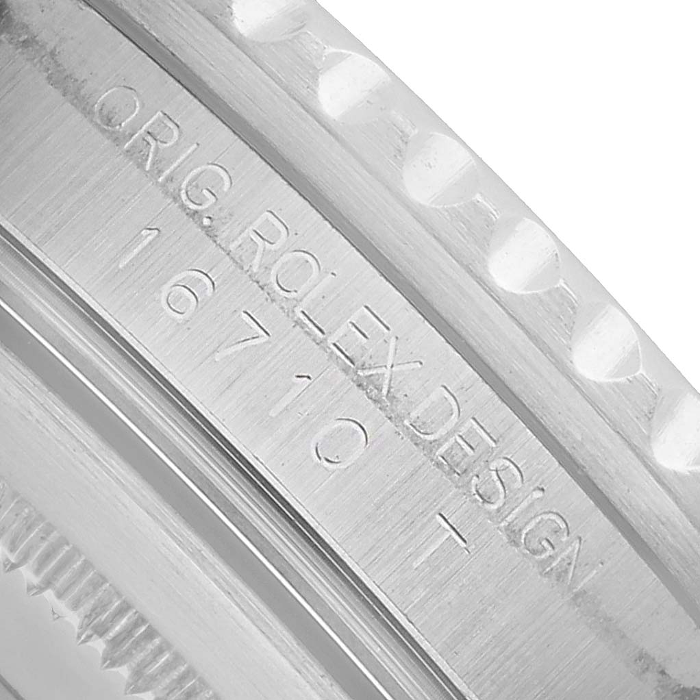 The image shows a close-up angle of the inner bezel's engraving on a Rolex GMT-Master 16710 Men's Stainless Steel Black Dial, displaying the model and design number.