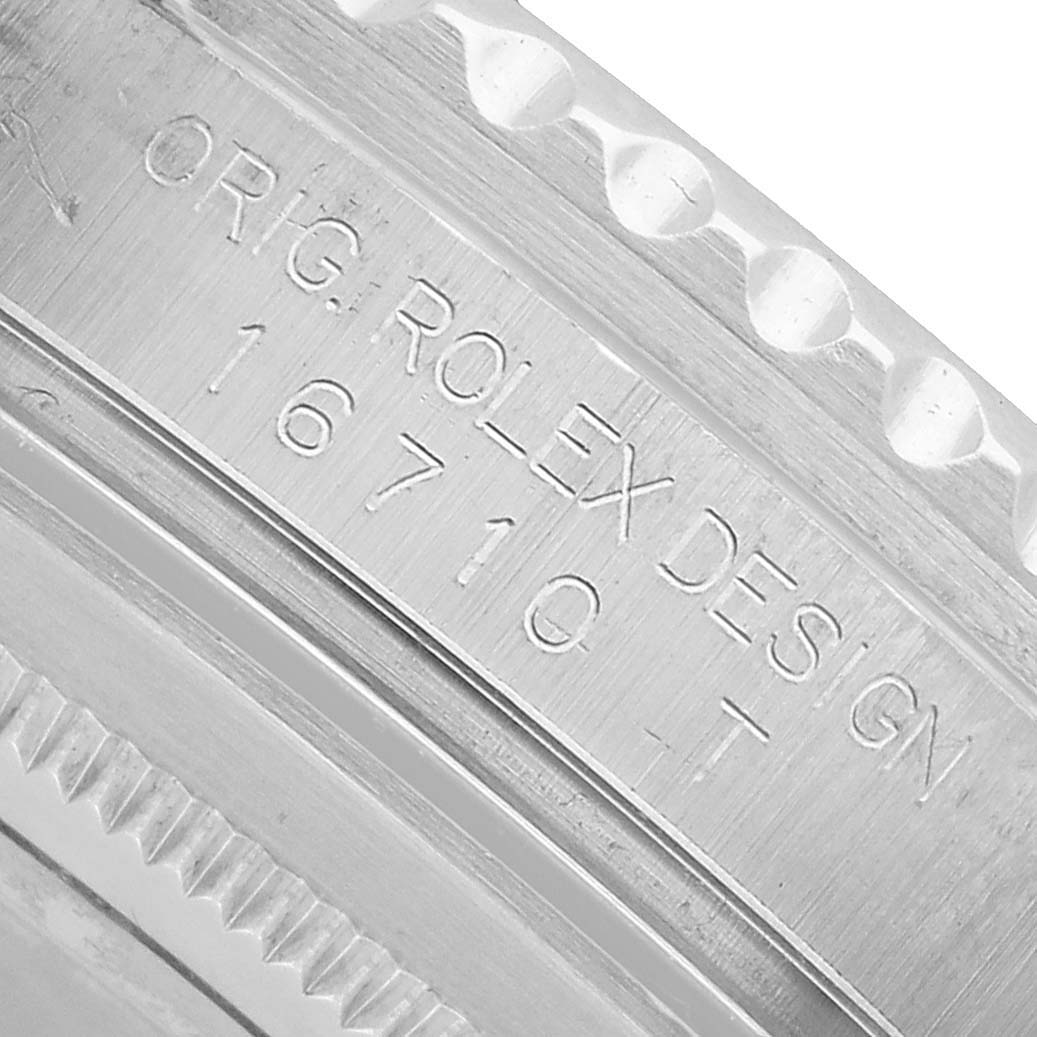 The image shows a close-up of the side with model details engraved on a Rolex GMT-Master 16710 Men's Stainless Steel Black Dial watch bezel.
