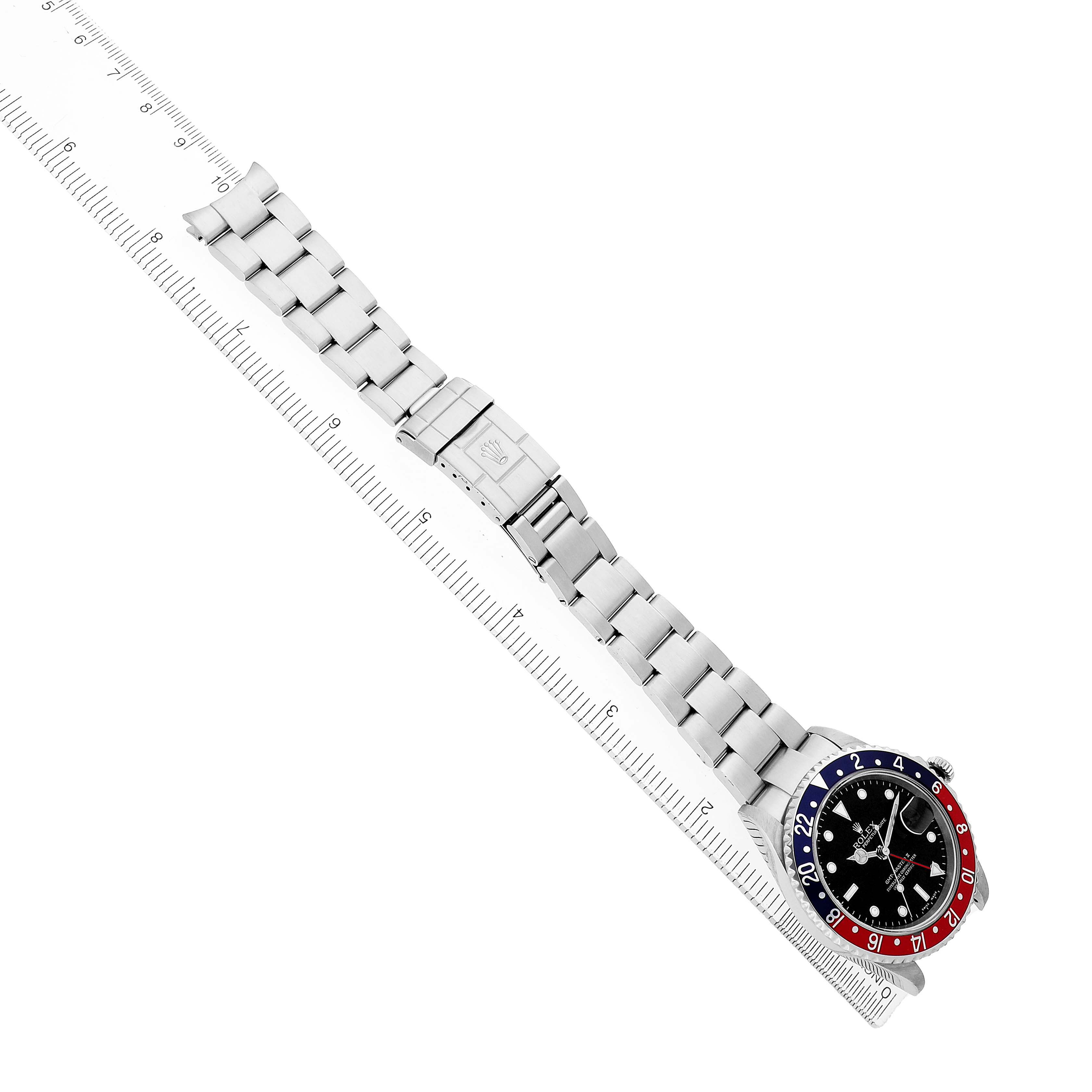 The image shows a side angle of a Rolex GMT-Master 16710 Men's Stainless Steel Black Dial watch, highlighting the full bracelet and clasp beside a ruler.