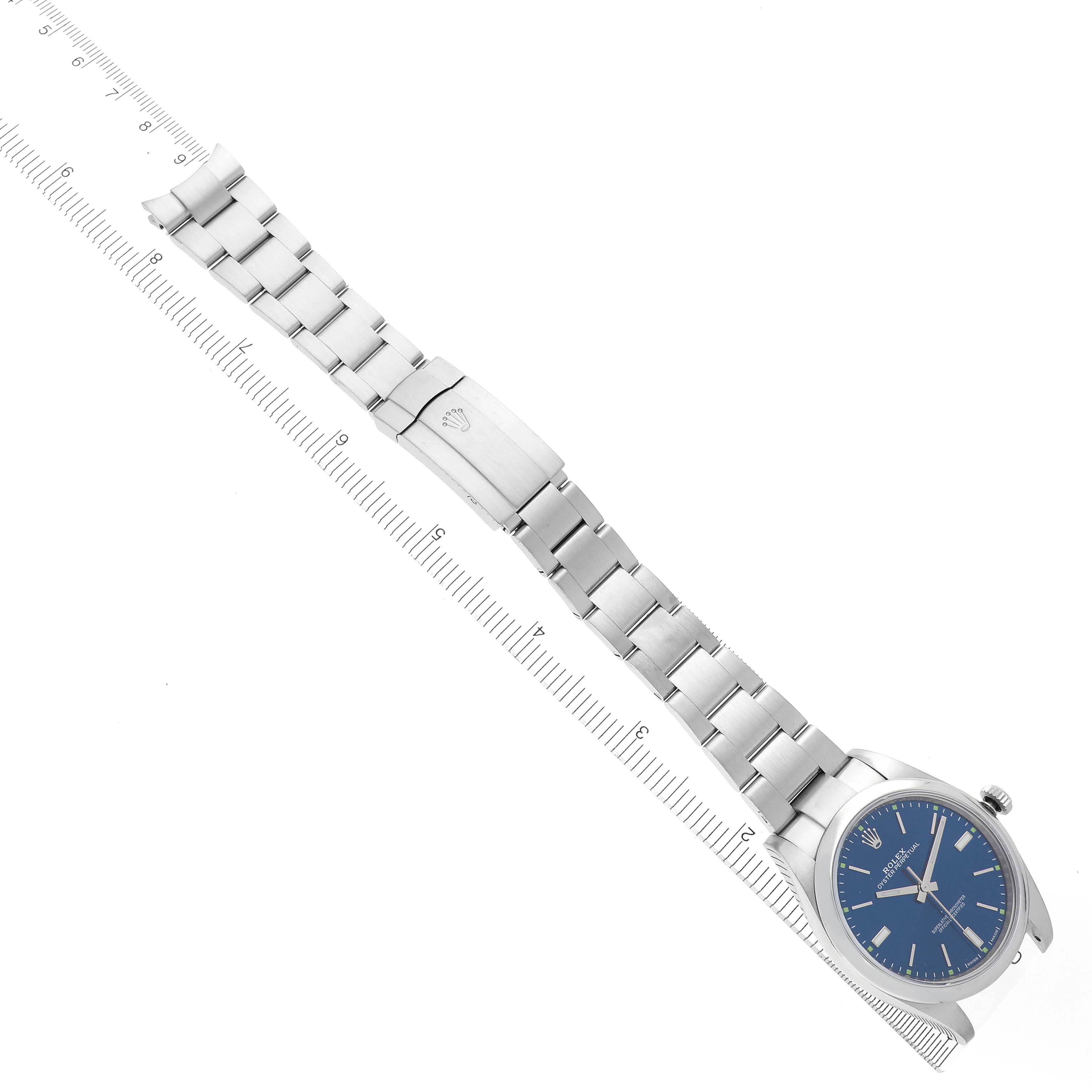 The Rolex Oyster Perpetual 114300 Men's Stainless Steel Blue Dial 114300 Men's Stainless Steel Blue Dial watch is displayed diagonally, showing the blue face, stainless steel bracelet, and clasp.