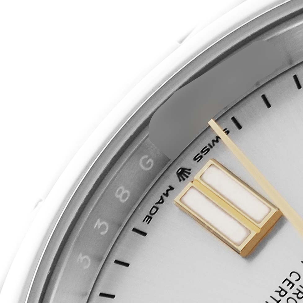 This close-up shows part of the dial of a Rolex Oyster Perpetual 124300 Men's Stainless Steel Silver Dial 124300 Men's Stainless Steel Silver Dial, focusing on the index markers and minute hand.